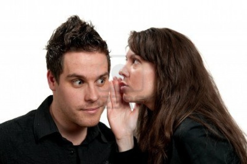 6970217-young-attractive-girl-whispering-to-a-young-man
